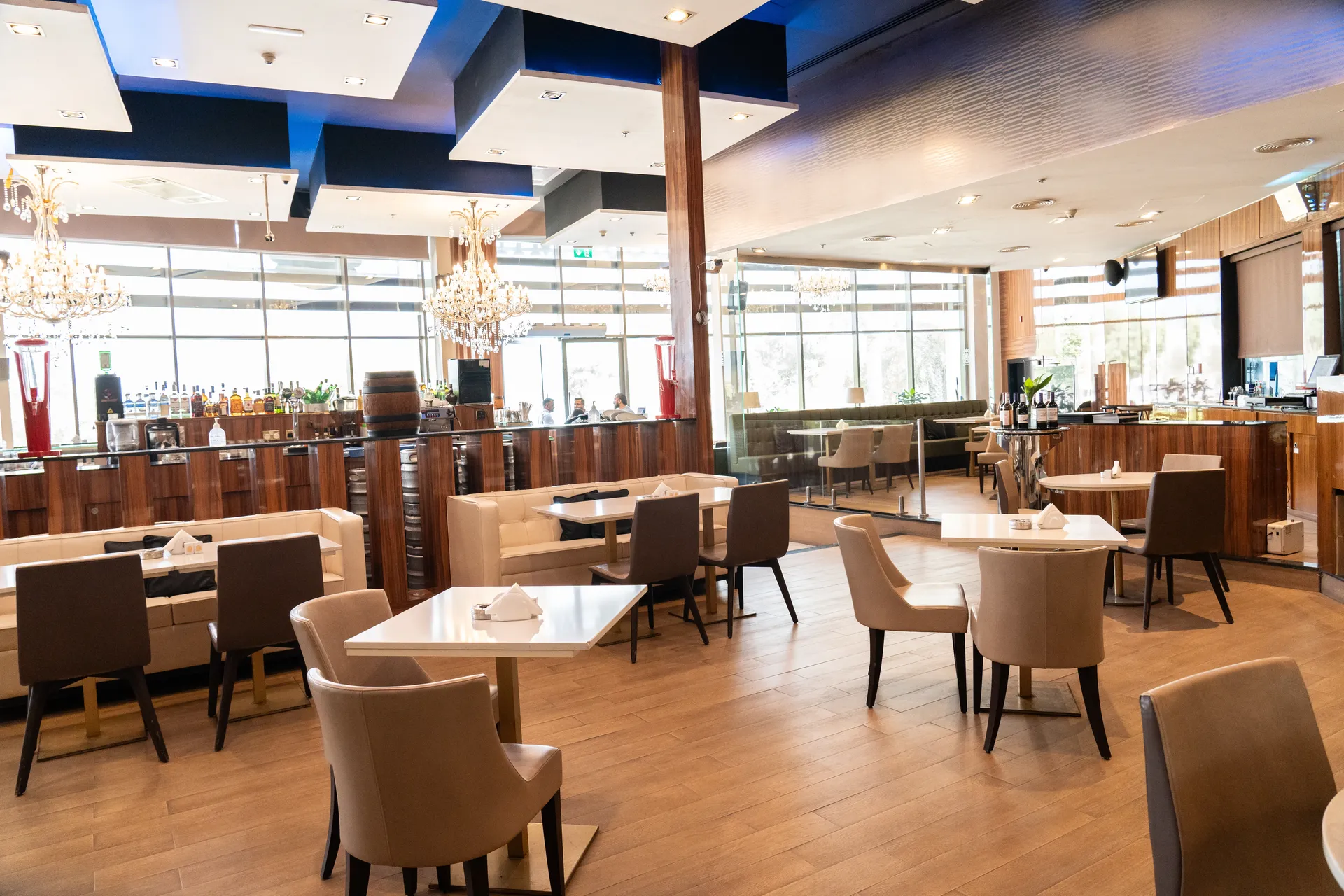 Interior dining lounge with white booths and wood paneled walls